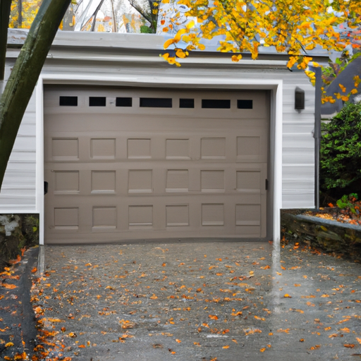 Residential garage in Maplewood, NJ with a modern steel door, visible weather seal, wet pavement, and autumn trees in background.