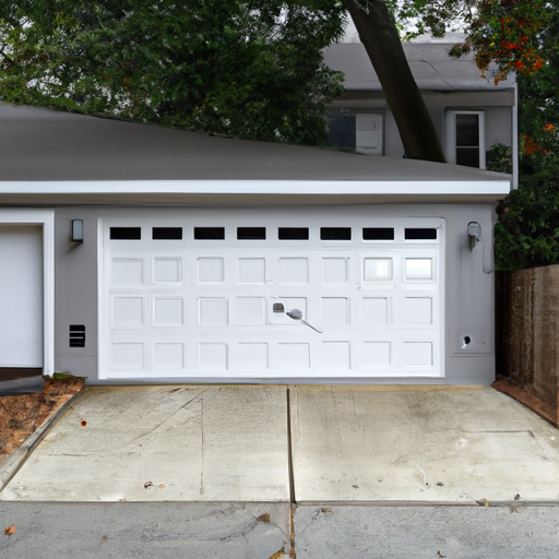 Suburban Maplewood driveway with a modern sectional garage door and visible smart opener housing, late-afternoon light.